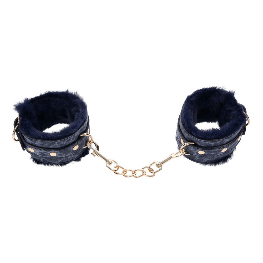 Navy blue faux fur handcuffs with gold chain and buckles for luxurious bondage play, top view | Flirty Bay online adult store, adult toys and lingerie